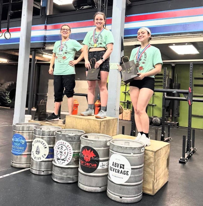 Group standing by Young Savage barrels